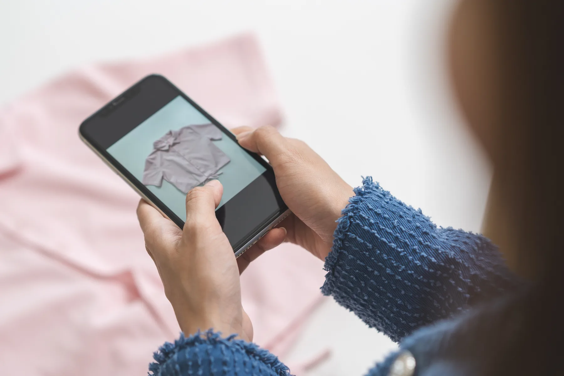 A fashion retailer photographing clothing products for an online store catalog